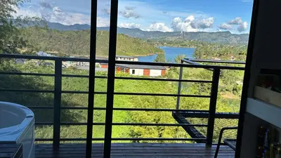 a view of a river from the balcony of a house at Finca hotel xamai in Guatapé