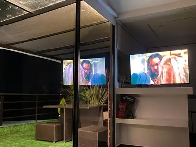 a room with two televisions on a wall at Finca hotel xamai in Guatapé