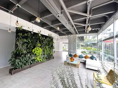 a living room with a large wall of plants at Amazing view Modern Apartment in Sabaneta in Sabaneta