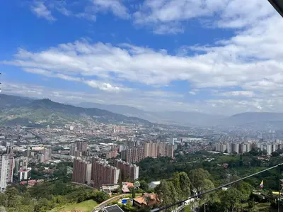 a view of a city with buildings and mountains at Amazing view Modern Apartment in Sabaneta in Sabaneta