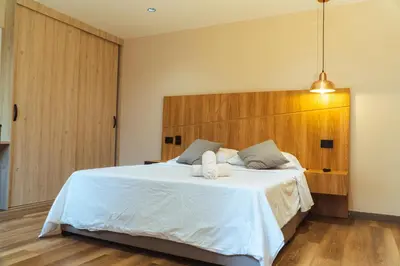 a bedroom with a large bed with two towels on it at Casa Origo Hospedaje in Medellín