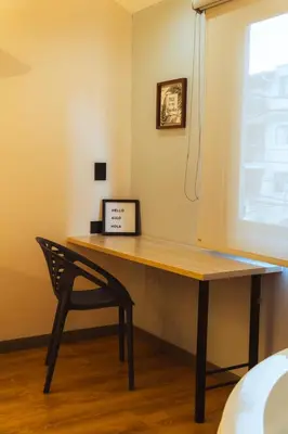 a desk with a chair next to a window at Casa Origo Hospedaje in Medellín
