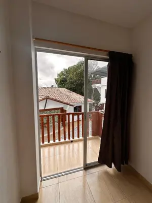 a sliding glass door with a view of a balcony at hotel montana Doradal in Doradal