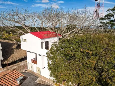 an aerial view of a white house with a red roof at hotel montana Doradal in Doradal