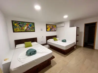 a room with two beds in a room at hotel montana Doradal in Doradal