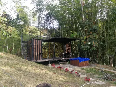 a tree house in the middle of a hill at Refugio Selvatico in Guatapé