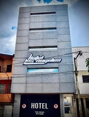 a hotel sign on the side of a building at Hotel Los Ángeles in Bello