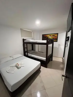 a small room with two bunk beds in it at Hotel Los Ángeles in Bello