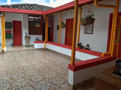 a house with a tile floor and red doors at Casa Nohelia in Jericó