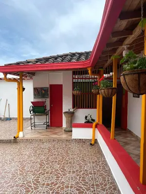 a house with a red roof and a patio at Casa Nohelia in Jericó