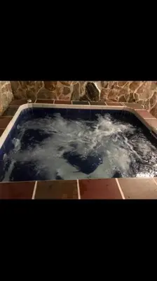a pool of water with clouds in it at Agua Azul Cabaña 87 in San Jerónimo