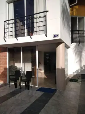 a building with two chairs and a balcony at Agua Azul Cabaña 87 in San Jerónimo