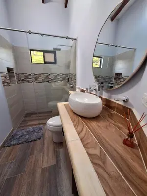 a bathroom with a sink and a mirror at Casa Campestre Guatapé acceso directo a la represa in Guatapé