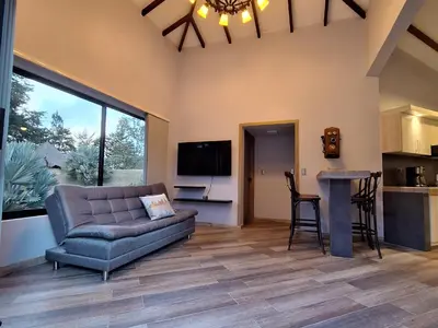 a living room with a couch and a table at Casa Campestre Guatapé acceso directo a la represa in Guatapé