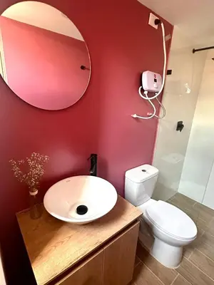a bathroom with a sink and a toilet and a mirror at 81 Living by Simple Stay in Medellín
