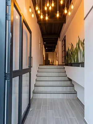 a set of stairs in a building with a door at 81 Living by Simple Stay in Medellín