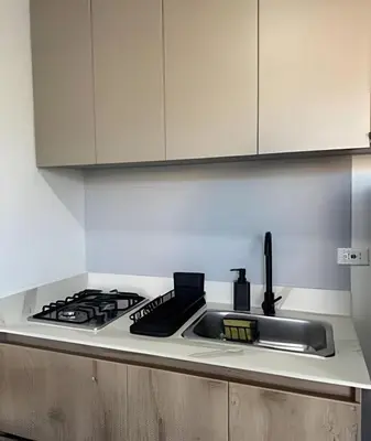 a kitchen counter with a sink and a stove at 81 Living by Simple Stay in Medellín