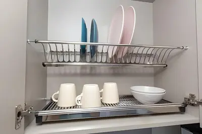 a shelf with plates and utensils in a kitchen at 81 Living by Simple Stay in Medellín