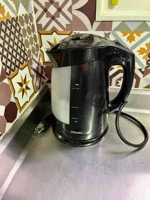 a black tea kettle sitting on a kitchen counter at Alojamiento turístico laureles, buena ubicación in Medellín