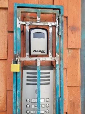 a cell phone is attached to a brick wall at Alojamiento turístico laureles, buena ubicación in Medellín