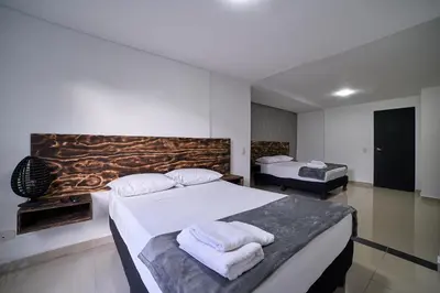 a bedroom with two beds with towels on them at Farum Hotels in Medellín