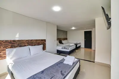a bedroom with two beds in a room with at Farum Hotels in Medellín