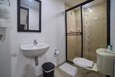 a bathroom with a sink and a toilet and a shower at Farum Hotels in Medellín