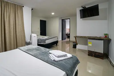 a hospital room with two beds and a tv at Farum Hotels in Medellín
