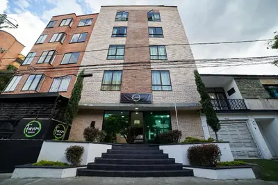 a tall brick building with stairs in front of it at Farum Hotels in Medellín