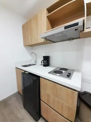 a small kitchen with a sink and a stove at MEDELLIN CÓMODOS APARTAESTUDIOS in Medellín