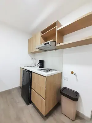 a small kitchen with a sink and a stove at MEDELLIN CÓMODOS APARTAESTUDIOS in Medellín