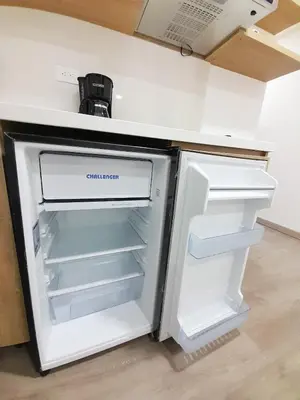 an empty refrigerator with its door open in a kitchen at MEDELLIN CÓMODOS APARTAESTUDIOS in Medellín