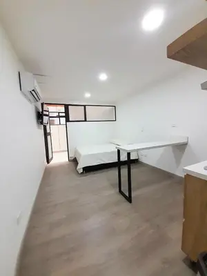 a white room with a desk and a bed at MEDELLIN CÓMODOS APARTAESTUDIOS in Medellín
