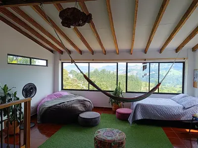 a room with two beds and a hammock in it at Apartamento Wiphala, Vista Panorámica in Jericó