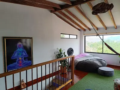 a bedroom with a bed and a large window at Apartamento Wiphala, Vista Panorámica in Jericó