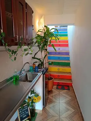a kitchen with a sink and a colorful staircase at Apartamento Wiphala, Vista Panorámica in Jericó