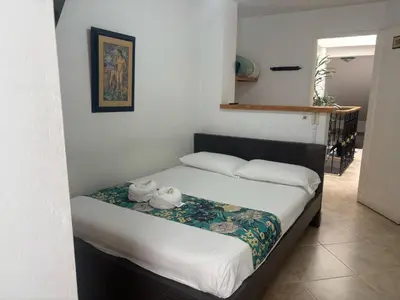 a bedroom with a bed with two towels on it at Hotel Portal Guatapé in Guatapé
