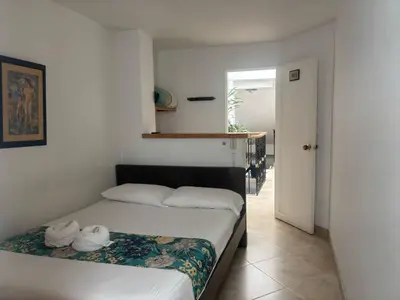 a bedroom with a bed with towels on it at Hotel Portal Guatapé in Guatapé