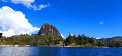 a mountain sitting on top of a large body of water at Hotel Portal Guatapé in Guatapé