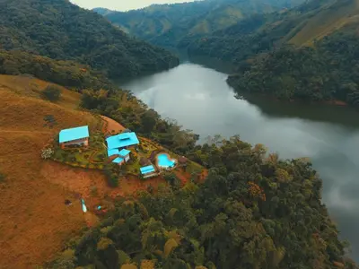 an aerial view of a house on a hill next to a river at Ecohotel Campo Alegre Norcasia Caldas in Norcasia