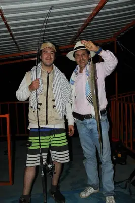 two men are posing for a picture while holding fishing poles at Ecohotel Campo Alegre Norcasia Caldas in Norcasia