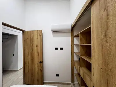 a room with a closet with a wooden door at Apartamentos de lujos para descansar Oasis in San Jerónimo