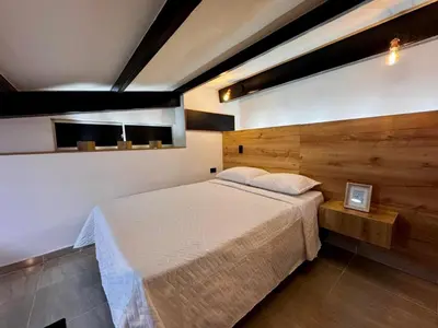 a bedroom with a large bed in a room at Apartamentos de lujos para descansar Oasis in San Jerónimo