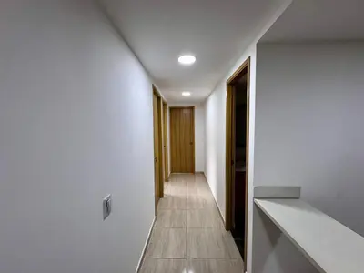 a hallway of a house with white walls and wooden floors at Apartamentos de lujos para descansar Oasis in San Jerónimo