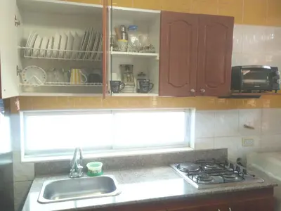 a kitchen with a sink and a stove and a window at 