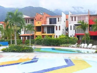 a swimming pool with chairs and buildings in the background at 