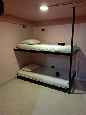 two bunk beds are in a room with at Hostal Casa Primavera in Medellín
