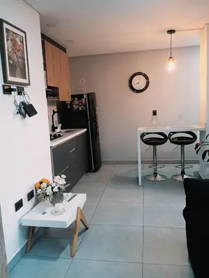 a kitchen with a table and two stools at Apartamento exclusivo en Sabaneta, Antioquia in Sabaneta