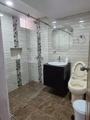 a bathroom with a toilet and a sink and a shower at ECXEPCIONAL y ELEGANTE APARTAMENTO in Medellín