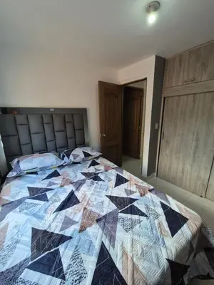 a quilt on a bed in a bedroom at ECXEPCIONAL y ELEGANTE APARTAMENTO in Medellín
